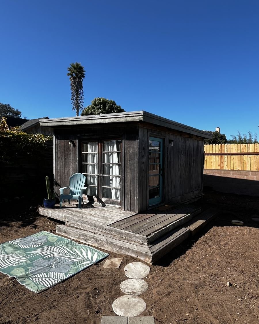 Melody's garden studio in Baywood-Los Osos, a wooden cabin with French doors and a small deck